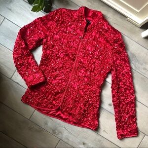 Adressing woman smocked crinkle sequin mock neck jacket in vibrant red. Size L